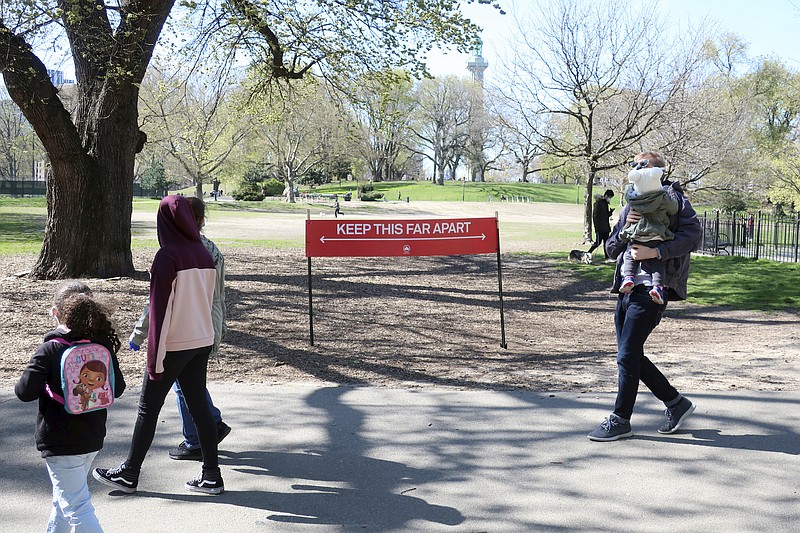 Photo by Ted Shaffrey of The Associated Press / A sign in Fort Greene Park in Brooklyn, New York City, reminds people to social distance during the coronavirus pandemic on on Wednesday, April 22, 2020.