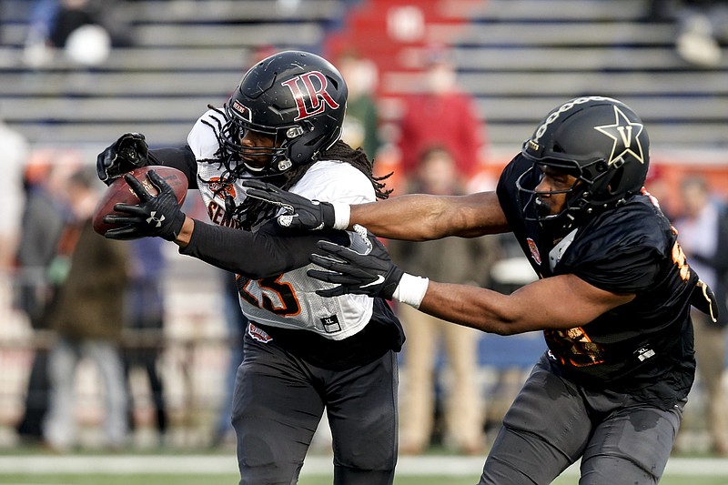 AP photo by Butch Dill / Lenoir-Rhyne defensive back Kyle Dugger intercepts a pass intended for Vanderbilt tight end Jared Pinkney as the South squad practices for the 2020 Senior Bowl on Jan. 22 in Mobile, Ala.