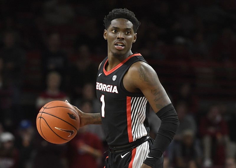 n this Jan. 29, 2019, photo, Georgia guard Teshaun Hightower (1) against Arkansas during the second half of an NCAA college basketball game in Fayetteville, Ark. Hightower, now Tulane University's leading scorer, was booked into jail Saturday, April 25, 2020, on multiple charges, including murder and aggravated assault, Henry County Jail records show. (AP Photo/Michael Woods, File)