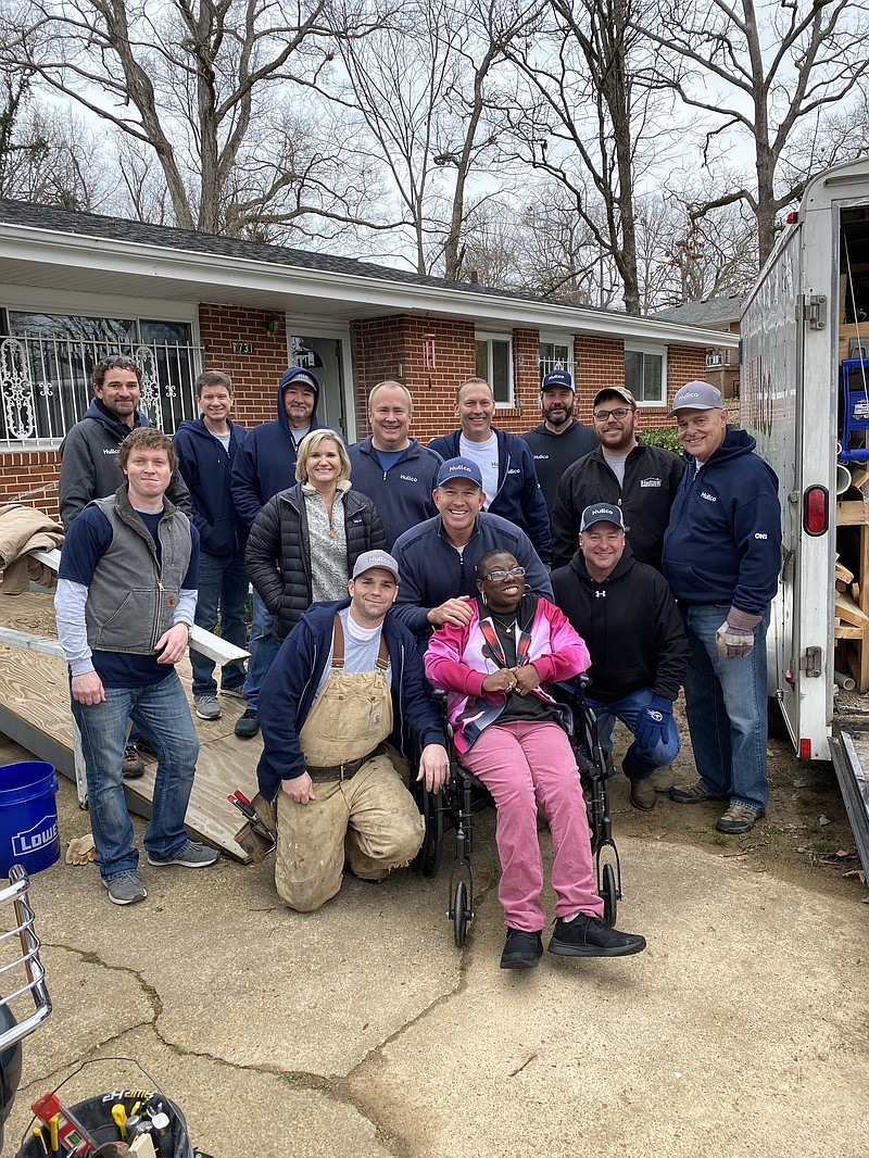 Photo contributed by HullCo / Pictured left to right, back to front: HullCo employees Sam Hughes, Matt Gainer, Fred Whitson, Gary Capp, Rusty Jones, Jamey Malone, Kenny Westermyer, Jim Cutler, Matt Gillenwater, Tammy Capp, Matt Hullander, Bobby Winnie, Michael Frady, with homeowner Laticia Boyd. The HullCo team made repairs to Boyd's home as part of a company community service project.