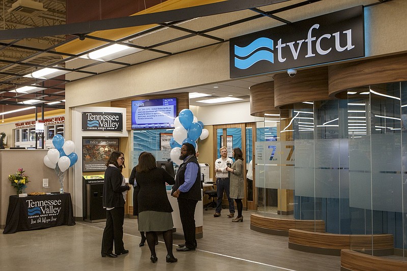 People mingle outside of the Tennessee Valley Federal Credit Union branch inside of a new Food City in January 2019 in Ringgold, Georgia.