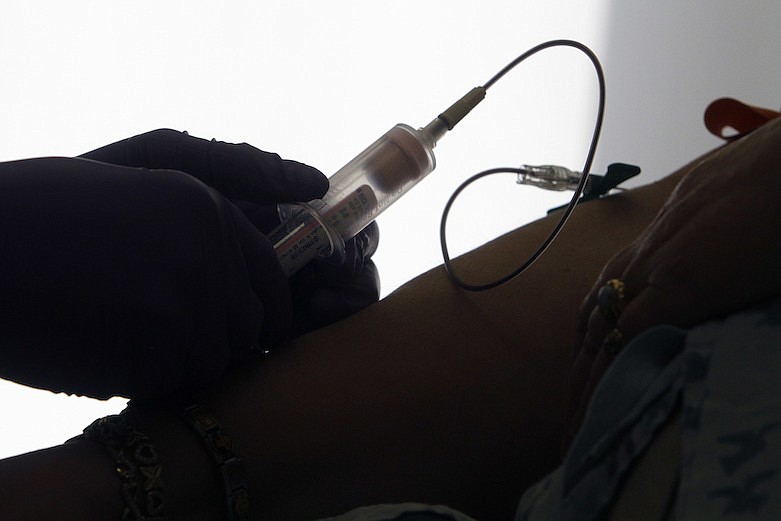 In this April 28, 2015 file photo, a patient has her blood drawn for a liquid biopsy at a hospital in Philadelphia. According to results released on Tuesday, April 28, 2020, for the first time, a blood test has been shown to help detect many types of cancer in a study of thousands of women with no symptoms of the disease. The test is still experimental and even its fans say it needs to be improved. (AP Photo/Jacqueline Larma)