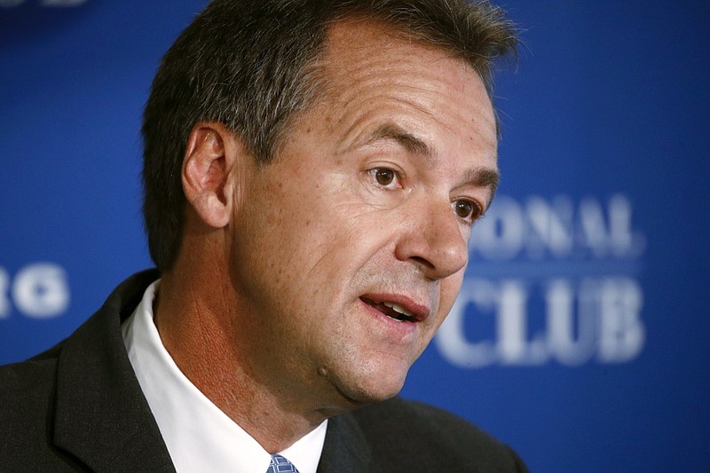FILE - In this Aug. 7, 2019 file photo, Democratic Montana Gov. Steve Bullock speaks at the National Press Club in Washington. Bullock was the lame-duck governor of solidly red Montana, fresh off a failed Democratic presidential bid, when he pivoted and announced he'd challenge Republican Sen. Steve Daines for his seat. But days after he announced his candidacy last month, the coronavirus claimed its first cases in Montana. That shifted the spotlight onto Bullock as he leads the state's pandemic response, leaving Daines in the unusual position of a sitting senator competing for attention. (AP Photo/Patrick Semansky, File)