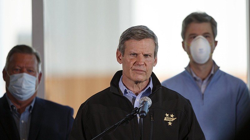 Staff photo by C.B. Schmelter / Flanked by Chattanooga Mayor Andy Berke, right, and Hamilton County Mayor Jim Coppinger, Gov. Bill Lee, center, speaks during a news conference at Wilson Air Center on Tuesday, April 14, 2020 in Chattanooga, Tenn.