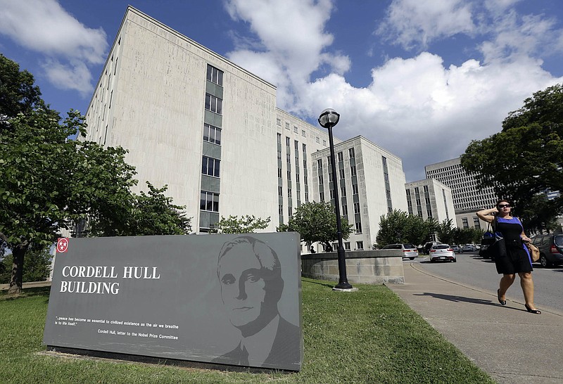 A woman walks past the Cordell Hull Building on Tuesday, July 2, 2013, in Nashville, Tenn. The state is reassessing 5 million square feet of office space and Gov. Bill Haslam has plans to tear the building down. Thousands of state workers have been asked to move and many others are expected to be asked in the near future. (AP Photo/Mark Humphrey)