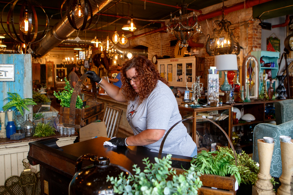 Staff photo by C.B. Schmelter / Danielle Webb, with Whiskey Glitter, cleans her store space at The Refindery on Wednesday, April 29, 2020 in Chattanooga, Tenn. Following the shutdown due to the coronavirus pandemic, the store is preparing to reopen on Friday, May 1.