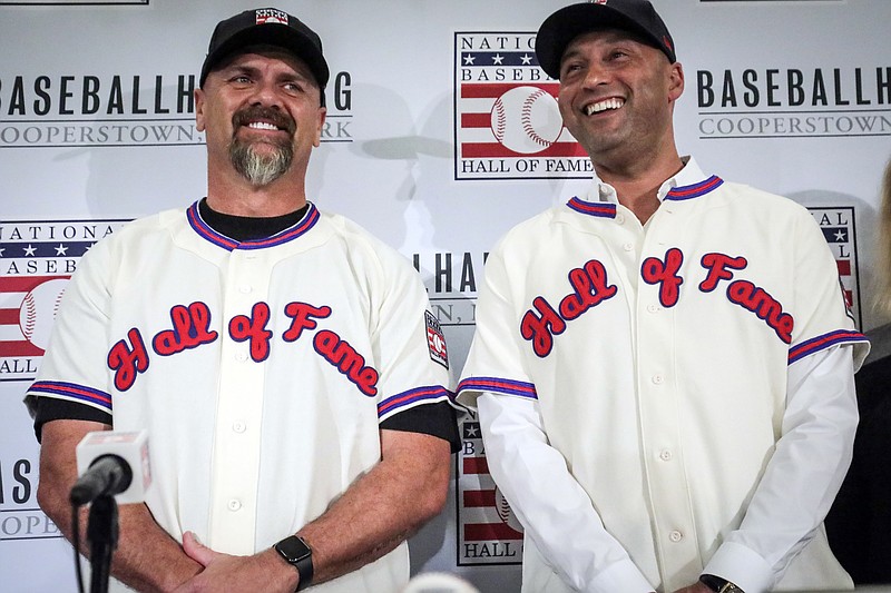 AP photo by Bebeto Matthews / Former New York Yankees shortstop Derek Jeter, right, and former Colorado Rockies outfielder Larry Walker pose after receiving their National Baseball Hall of Fame jerseys during a news conference on Jan. 22 in New York. Set to be inducted during a ceremony this summer in Cooperstown, they'll have to wait until 2021.