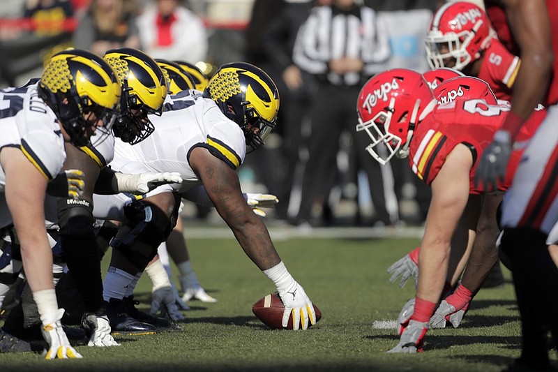 Michigan center Cesar Ruiz, center left, prepares to snap the ball against Maryland during the second half of an NCAA college football game, Saturday, Nov. 2, 2019, in College Park, Md. Michigan won 38-7. (AP Photo/Julio Cortez)
