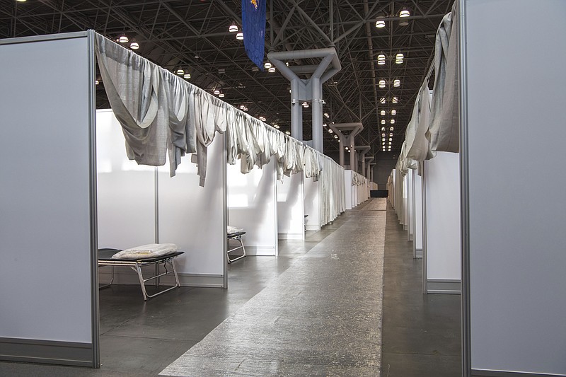 FILE - In this Friday, March 27, 2020, photo provided by Office of Governor Andrew M. Cuomo, makeshift hospital rooms stretch out along the floor at the Jacob Javits Convention Center in New York. Uncertainty in planning for the pandemic has left the globe dotted with dozens of barely used or unused temporary field hospitals. (Darren McGee/Office of Governor Andrew M. Cuomo via AP, File)


