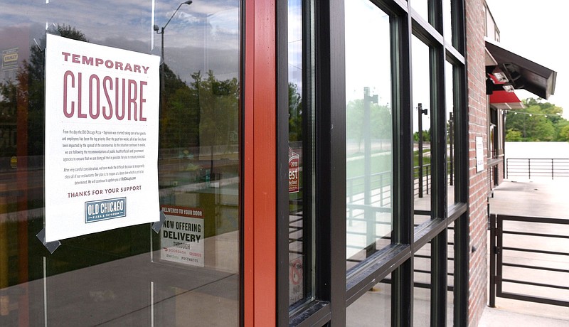 Staff Photo by Robin Rudd / A sign explains that the Old Chicago Pizza and Taproom, on Hamilton Place Boulevard, is closed.  Because of the measures taken to combat the COVID-19 pandemic businesses remained closed on April 29, 2020.