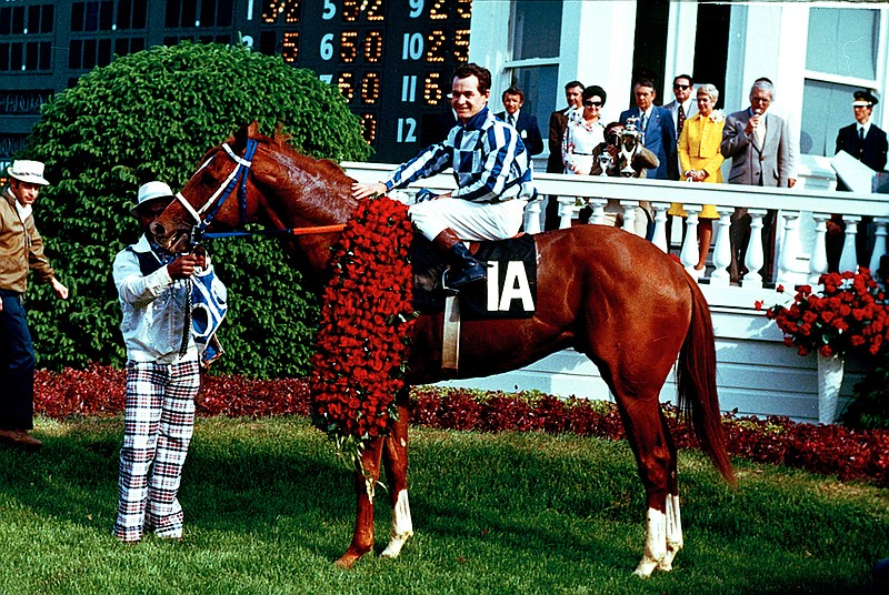 AP photo / Secretariat and jockey Ron Turcotte pose in the winner's circle at Churchill Downs after winning the 99th Kentucky Derby on May 5, 1973, in Louisville. At left is groom Ed Sweet. Secretariat won that year's "Run for the Roses" in a record 1:59 2/5, becoming the first horse to complete the 1 1/4-mile course for the Derby in less than two minutes. It also started a dominant run to the Triple Crown.