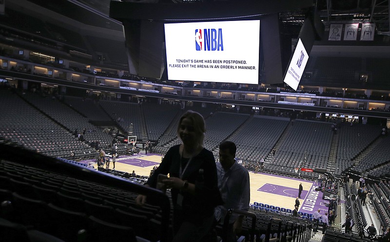 AP photo by Rich Pedroncelli / NBA fans leave the Golden 1 Center on March 11 in Sacramento, Calif., after the game between the host Kings and the New Orleans Pelicans was postponed at the last minute after Utah Jazz center Rudy Gobert tested positive for the novel coronavirus. The league suspended its season that night and has not played since.