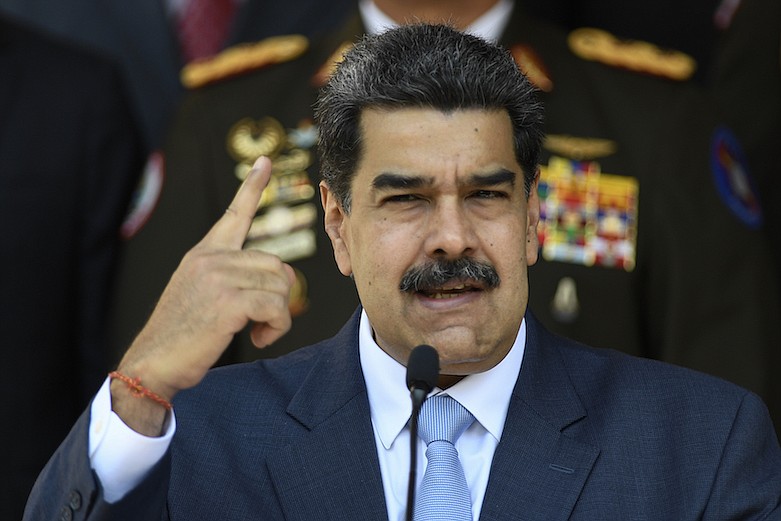 In this March 12, 2020 file photo, Venezuelan President Nicolas Maduro givesa press conference at the Miraflores presidential palace in Caracas, Venezuela. When hints of a cross border conspiracy staged from Colombia to raid military bases and ignite a popular rebellion that would end in Maduro's arrest surfaced in March 2020, Venezuelan state media portrayed it as a Bay of Pigs redux ginned up by the CIA. (AP Photo/Matias Delacroix, File)