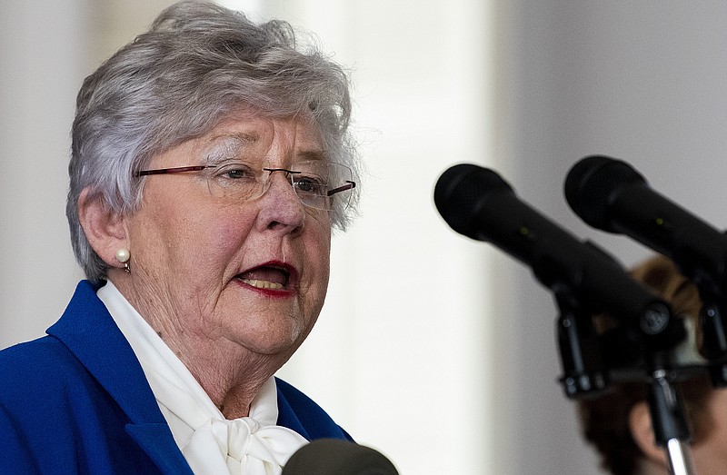 Governor Kay Ivey announces continued social distancing during her coronavirus update Tuesday, April 28, 2020 at the state capitol building in Montgomery, Ala. In the background is State Health Officer Dr. Scott Harris. (Mickey Welsh/The Montgomery Advertiser via AP)


