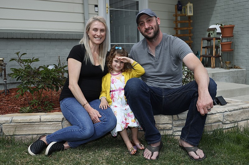 Eli Oderberg, right, sits with Katie Evers and their 4-year-old daughter, Everlee, outside their home in southeast Denver on Thursday, April 30, 2020. Oderberg, like 30 million people around the United States who have filed for unemployment benefits after losing their jobs during the coronavirus pandemic, is facing the specter of paying the monthly rent with the flip of the calendar. (AP Photo/David Zalubowski)


