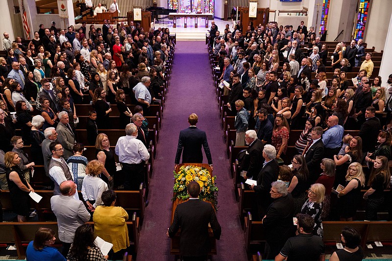 Staff photo by Doug Strickland / The casket of author Rachel Held Evans is borne into her funeral at First-Centenary United Methodist Church on Saturday, June 1, 2019, in Chattanooga, Tenn. Evans was a Dayton, Tenn., resident who authored books including "A Year of Biblical Womanhood," "Searching for Sunday" and "Inspired: Slaying Giants, Walking on Water, and Loving the Bible Again."