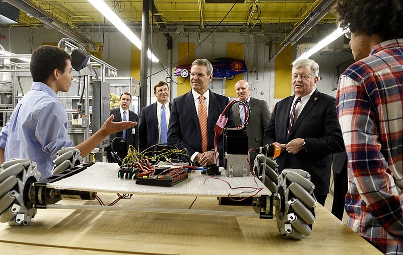 Staff Photo by Robin Rudd/   Tennessee Governor Bill Lee, center, listens as Cleveland High School students Michael Adriaanse, left, and Trae Allan Parker, explain the operations of the engineering lab at the school on Tuesday morning.  Also listening, from left, are Chief Academic Officer for Cleveland City Schools Jeff Elliott, Cleveland Director of Schools Dr. Russell Dyer, Governor Lee, state representative Mark Hall, and Lieutenant Governor Randy McNally.  Bill lee toured the school to see the work teachers and students are doing to prepare students for career, college, and life readiness.  While at the school, Lee spend time with teachers and student ambassadors in fields such as health science and engineering.  