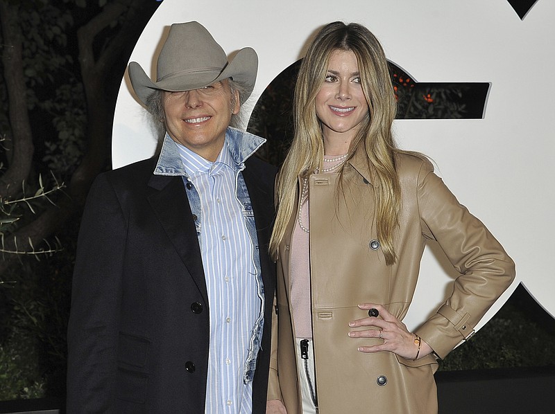 This Dec. 5, 2019 file photo shows Dwight Yoakam, left, and Emily Joyce at GQ's Men of the Year Celebration in West Hollywood, Calif. The couple were married in March just prior to the quarantine in a private ceremony at St Monica Catholic Church in Santa Monica, Calif. (Photo by Richard Shotwell/Invision/AP, File)