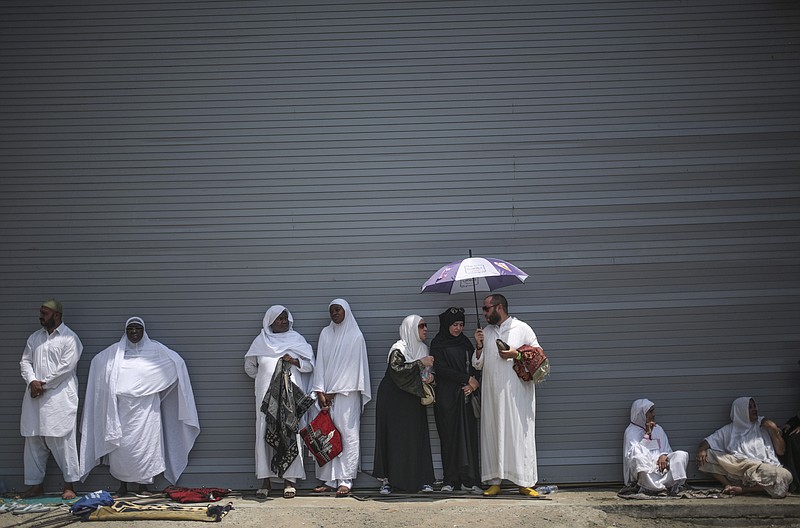 FILE - In this Sept. 18, 2015 file photo, Muslim pilgrims shelter themselves from the heat as they attend Friday afternoon prayers outside the Grand Mosque in the holy city of Mecca, Saudi Arabia. A new study released Monday, May 4, 2020, says 2 to 3.5 billion people in 50 years will be living in a climate that historically has proven just too hot to handle. Currently about 20 million people live in places with an annual average temperature greater than 84 degrees (29 degrees Celsius) — far beyond the temperature sweet spot. That area is less than 1% of the Earth's land, and it is mostly near the Sahara Desert and includes Mecca, Saudi Arabia. (AP Photo/Mosa'ab Elshamy, File)


