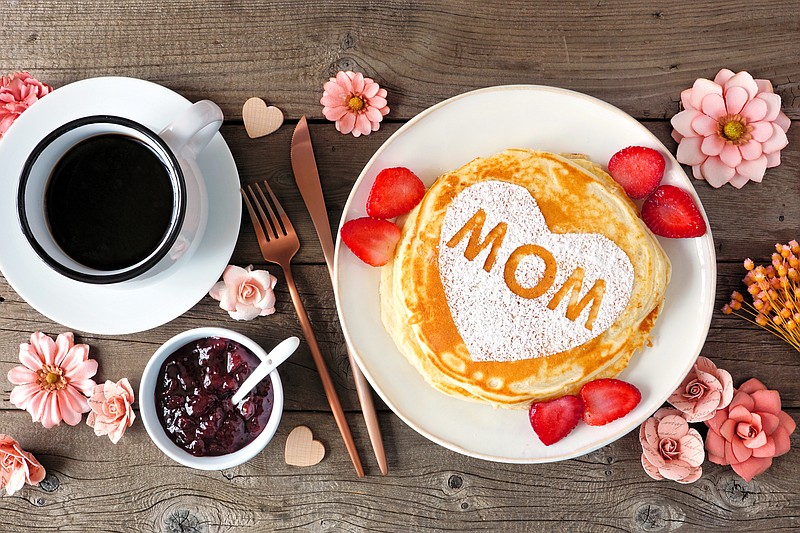 Mothers Day breakfast pancakes with heart shape and MOM letters, overhead view table scene on rustic wood - stock photo mother's day tile food tile / Getty Images
