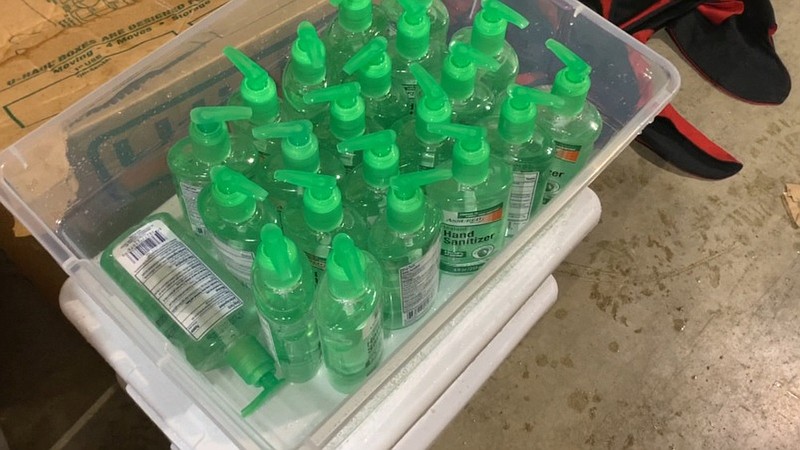 Bottles of hand sanitizer await distribution.
