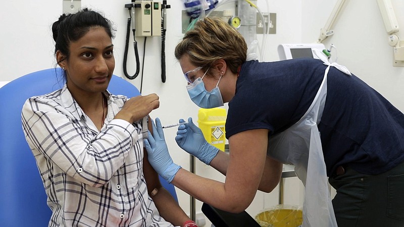In this screen grab from video issued by Britain's Oxford University, a volunteer is injected with either an experimental COVID-19 vaccine or a comparison shot as part of the first human trials in the U.K. to test a potential vaccine, led by Oxford University in England on April 25, 2020. About 100 research groups around the world are pursuing vaccines against the coronavirus, with nearly a dozen in early stages of human trials or poised to start. (University of Oxford via AP)


