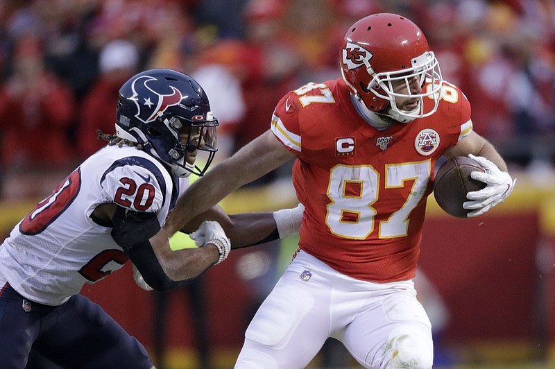 AP photo by Charlie Riedel / Kansas City Chiefs tight end Travis Kelce, right, tries to escape Houston Texans safety Justin Reid during a divisional playoff game on Jan. 12 in Kansas City, Mo.