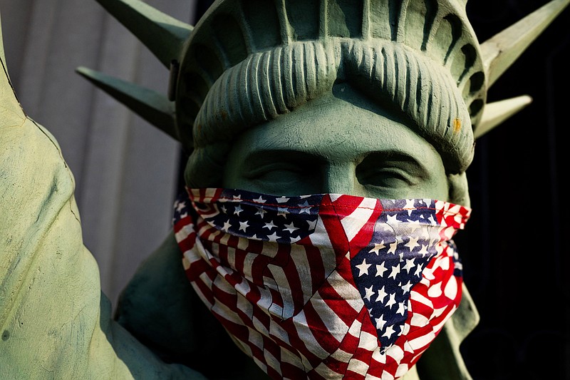 File, The New York Times / This masked replica of the Statue of Liberty was seen on the front porch of a Brooklyn home in early April.