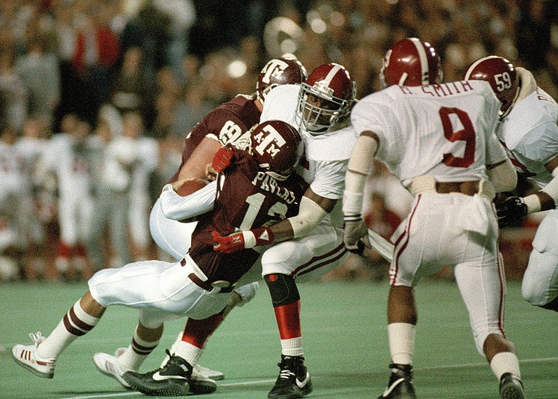 AP photo by David Breslauer / Alabama linebacker Derrick Thomas sacks Texas A&M's Lance Pavlas for a 4-yard loss during the first half of the Dec. 1, 1988, game that was dubbed the "Hurricane Bowl." Thomas set Crimson Tide single-game records with seven tackles for loss and five sacks in the game.