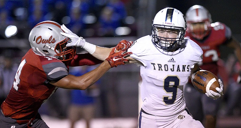 Staff photo by Robin Rudd / Soddy-Daisy's Hayden Maynor stiff-arms Ooltewah's Chase Sanders on Sept. 21, 2018, in Ooltewah.