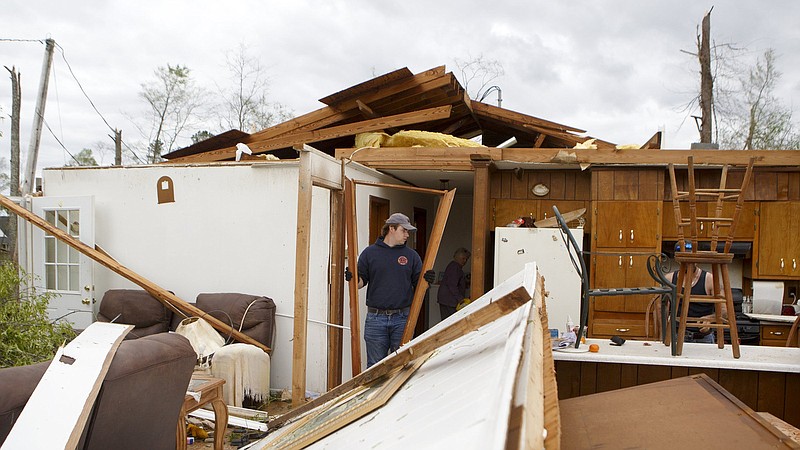 Staff photo by C.B. Schmelter / Caleb Chastain helps to clear the damage in Charles and Emma Prichett's home on Monday, April 13, 2020 in Chatsworth, Ga. Deadly storms tore through Northwest Georgia last month.