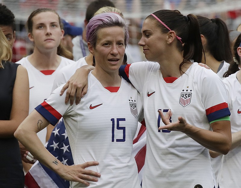 AP photo by Alessandra Tarantino / Megan Rapinoe, left, talks to teammate Alex Morgan after the United States won the Women's World Cup on July 7, 2019, in France.