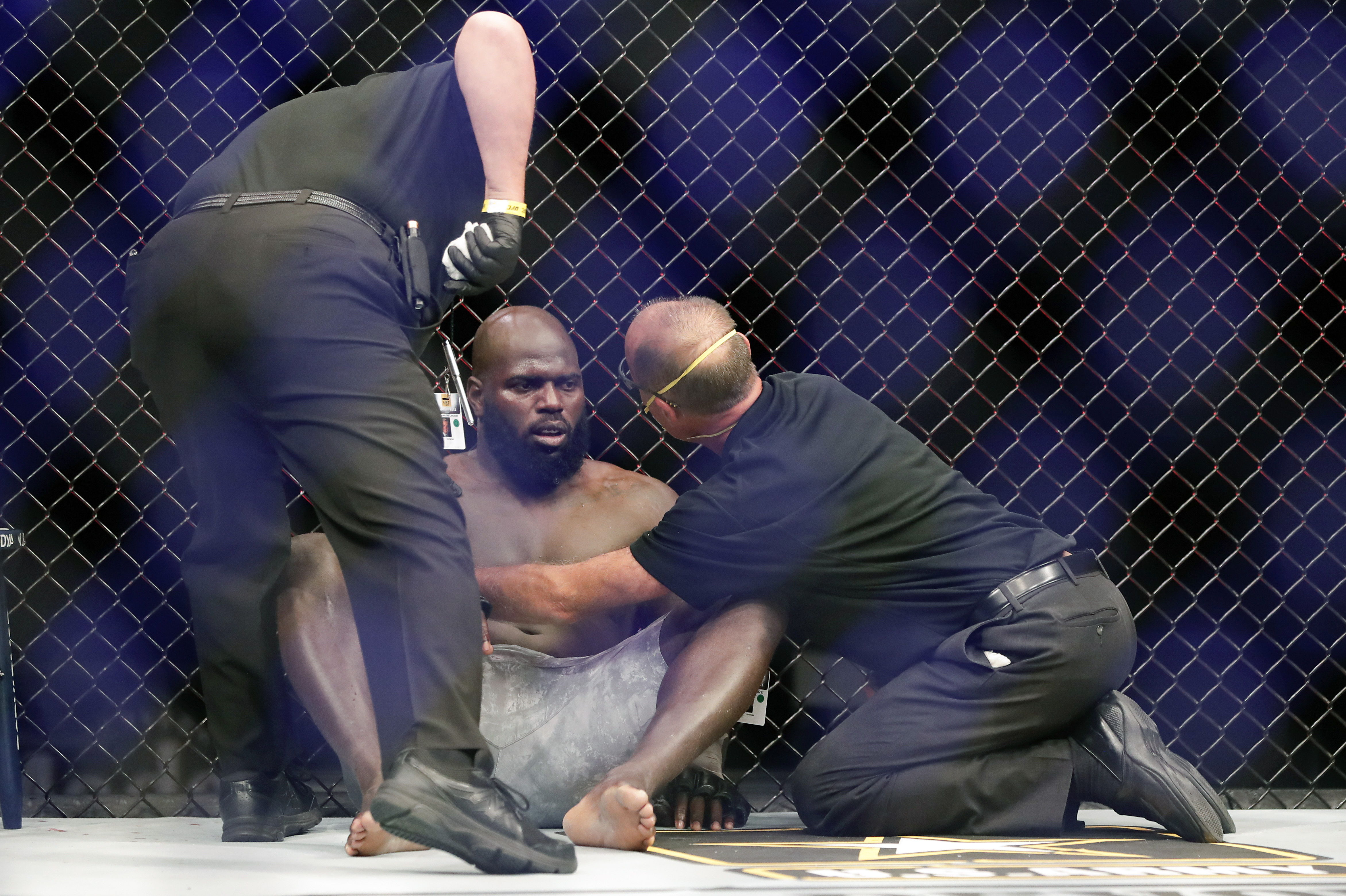 AP photo by John Raoux / Medical personnel check on Jairzinho Rozenstruik, center, after he was knocked out by Francis Ngannou in the first round of a UFC 249 bout Saturday night in Jacksonville, Fla.