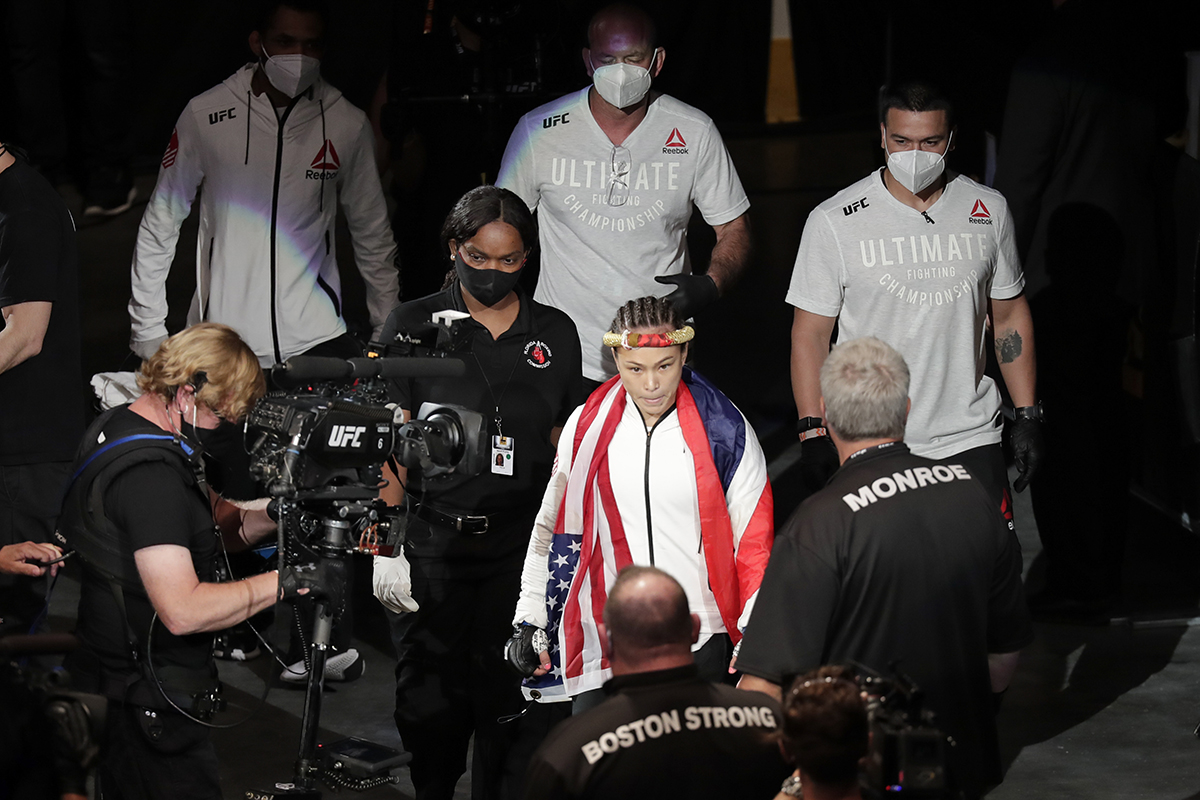 AP photo by John Raoux / Michelle Waterson, center, enters the arena before her fight against Carla Esparaza at UFC 249 on Saturday in Jacksonville, Fla.