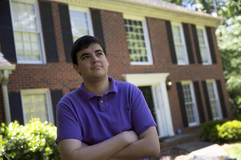 College student Jake Mershon poses in front of his parents home Thursday, May 7, 2020, in Roswell Ga. Mershon, who just finished his sophomore year at Florida State University in Tallahassee, moved back in with his mother, her fiance and his sister in Atlanta after on-campus classes shut down in mid-March. His mother included him on the census form for her household, and neither Mershon nor his three other roommates filled out a questionnaire for their Tallahassee apartment. (AP Photo/John Bazemore)