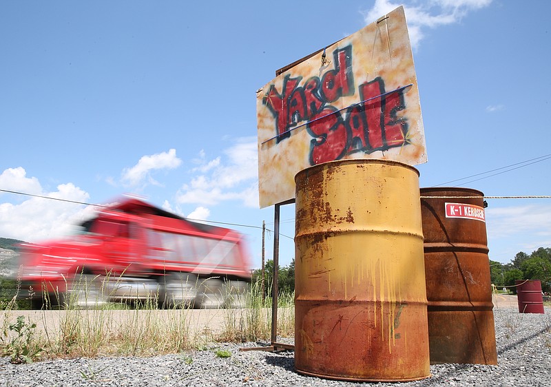 A truck drives by one vendor in the Antique Alley and Yard Sale route along U.S. Highway 11 in Ooltewah, Tenn., on Thurs., May 18, 2017. The event will run through May 21. 