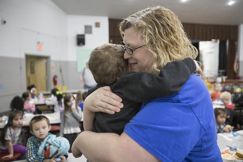 Staff File Photo By Troy Stolt / Pre-kindergarten teacher Amy Thompson hugs Aiden Massengale and tells him she's going to miss him on the last day of school in March before schools closed due to the COVID-19 virus.