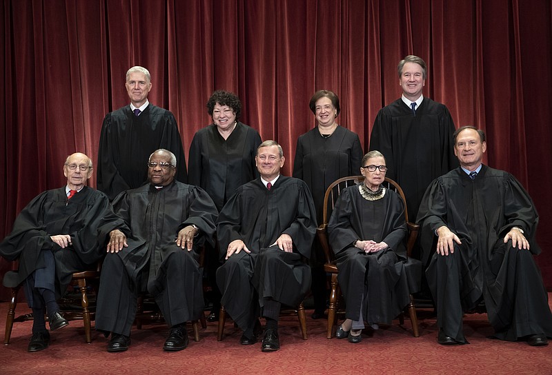 In this Nov. 30, 2018, file photo, the justices of the U.S. Supreme Court gather for a formal group portrait to include a new Associate Justice, top row, far right, at the Supreme Court Building in Washington. Seated from left: Associate Justice Stephen Breyer, Associate Justice Clarence Thomas, Chief Justice of the United States John G. Roberts, Associate Justice Ruth Bader Ginsburg and Associate Justice Samuel Alito Jr. Standing behind from left: Associate Justice Neil Gorsuch, Associate Justice Sonia Sotomayor, Associate Justice Elena Kagan and Associate Justice Brett M. Kavanaugh. (AP Photo/J. Scott Applewhite, File)