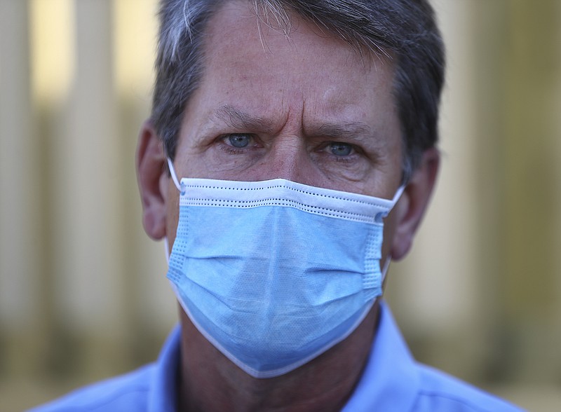 Georgia Gov. Brian Kemp wears a mask and urged fellow citizens to do the same after touring the temporary medical pod that has been placed at the Phoebe North Campus of Phoebe Putney Health System on Tuesday, May 5, 2020, in Albany, Ga. (Curtis Compton/Atlanta Journal-Constitution via AP)


