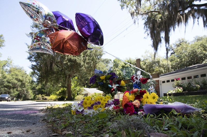 A memorial at the spot where Ahmaud Arbery was shot and killed is shown Friday, May 8, 2020, in Brunswick Ga. Two men have been charged with murder in the February shooting death of Arbery, a black man in his mid-20s, whom they had pursued in a truck after spotting him running in their neighborhood. (AP Photo/John Bazemore)


