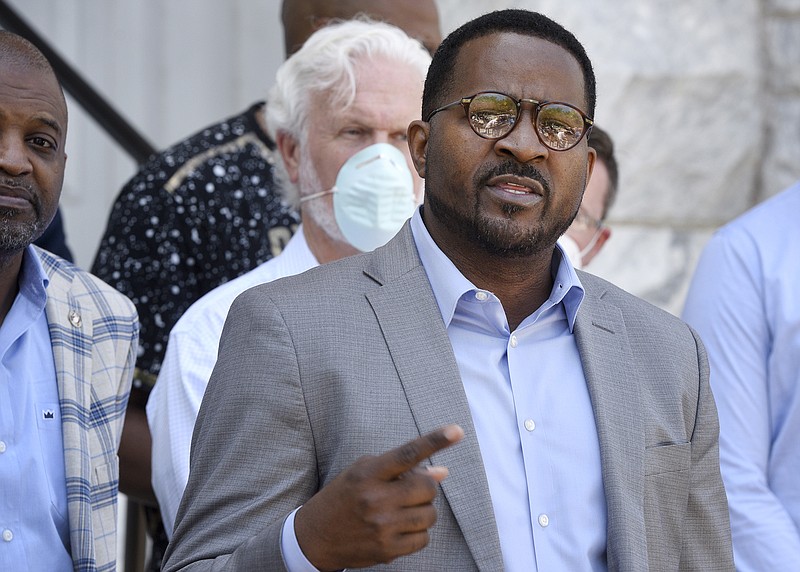 In this May 6, 2020, photo, flanked by area ministers, the Rev. John Perry III, president of the Brunswick, Ga., NAACP, addresses members of the media in front of old city hall. The people who call Brunswick home say it's not the monstrous place it might appear to be in the wake of the slaying of Ahmaud Arbery after a pursuit by two armed white men. Perry was "pleasantly surprised that the people here have a great heart," he said. (Bobby Haven/The Brunswick News via AP)


