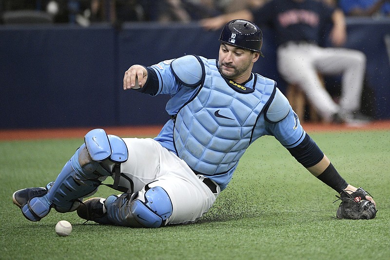 AP photo by Phelan M. Ebenhack / Tampa Bay Rays catcher Mike Zunino slides to pick up a wild pitch thrown by reliever Andrew Kittredge on Sept. 22, 2019, in St. Petersburg, Fla.