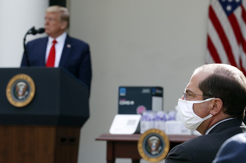 AP Photo, Alex Brandon / President Donald Trump and Health and Human Services Secretary Alex Azar listen as Brad Smith, director of the Center for Medicare & Medicaid Innovation, speaks about the coronavirus during a press briefing in the Rose Garden of the White House on Monday.