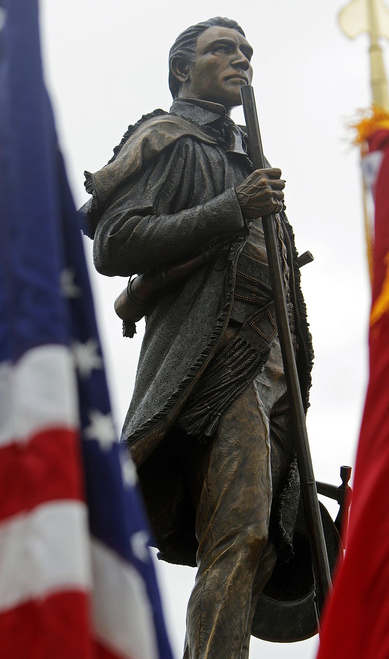 File photo by Wade Payne/special to the Knoxville News Sentinel / A statue of Sam Houston stands betwen flags during an unveiling ceremony on March 19, 2016, in Maryville, Tennessee.