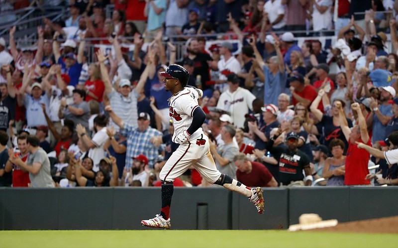 FILE - In this July 4, 2019, file photo, Atlanta Braves' Ozzie Albies rounds first base after hitting a three-run home run during the third inning of the team's baseball game against the Philadelphia Phillies in Atlanta. Major League Baseball owners gave the go-ahead Monday, May 11, 2020, to making a proposal to the players' union that could lead to the coronavirus-delayed season starting around the Fourth of July weekend in ballparks without fans, a plan that envisioned expanding the designated hitter to the National League for 2020. (AP Photo/John Bazemore, File)