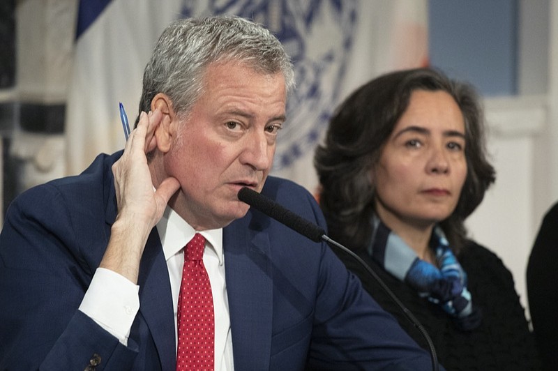 In this Feb. 26, 2020 file photo, Mayor Bill de Blasio, left, with Dr. Oxiris Barbot, commissioner of the New York City Department of Health and Mental Hygiene, listens to a reporter's question in New York. DeBlasio says he's investigating a report that the city's health commissioner spoke dismissively of the health concerns of police officers during a heated phone call with a top police commander in the early days of the coronavirus crisis. The Mayor said he wants to speak with Barbot and NYPD Chief of Department Terence Monahan to "understand exactly what happened" during the exchange in late March. (AP Photo/Mark Lennihan, File)



