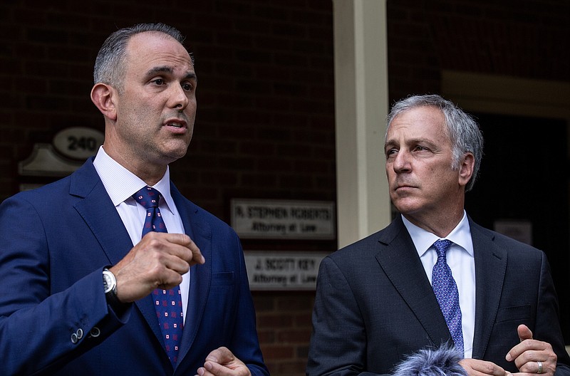 Attorney Jason Sheffield. left, and his law firm partner, Robert Rubin, respond to questions from the press outside their office on Thursday, May 14, 2020, in Decatur, Ga. After a video of the shooting of Ahmaud Arbery emerged on social media, the Georgia Bureau of Investigation, on Wednesday, arrested Gregory McMichael, 64, and his son, Travis McMichael, 34, and they were jailed on murder and aggravated assault charges. The attorneys are representing Travis McMichael. (AP Photo/Ron Harris)


