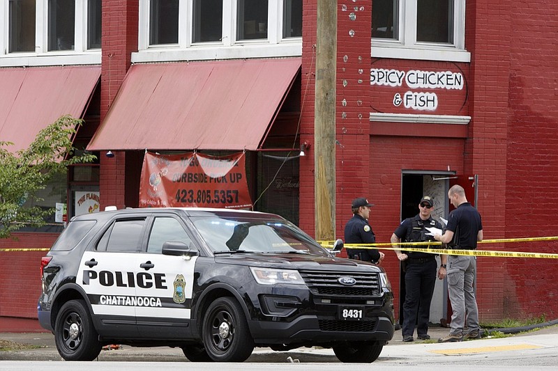 Staff photo by C.B. Schmelter / Police investigate a shooting outside the Flaming Rooster restaurant on Brainerd Road on Thursday, May 14, 2020 in Chattanooga, Tenn. According to police, one man was shot in what appears to be a drive-by shooting.