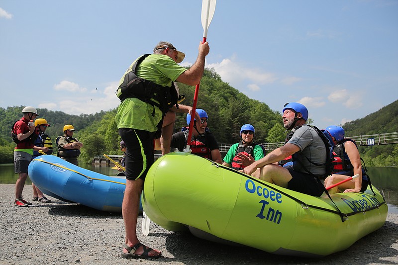 Staff photo by Erin O. Smith / Jimbo Kibler, a rafting guide, gives a quick safety briefing for, from left to right, Sen. Mike Bell, Bobby Wilson, Deputy Commissioner for the Bureau of Parks and Conservation Brock Hill and Vice President for Tourism and Development for the Cleveland/Bradley Chamber of Commerce Melissa Woody during an event in 2018, in Benton, Tenn. The Ocoee River is reopening Saturday for commercial rafting.