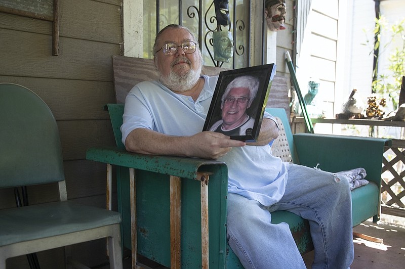 James Kelly poses with a photo of his late father also named James Kelly at his home Friday, May 1, 2020. Kelly had to delay his plans to travel Scotland, where he planned to scatter his father's ashes, because of the coronavirus outbreak (AP Photo/John Bazemore)


